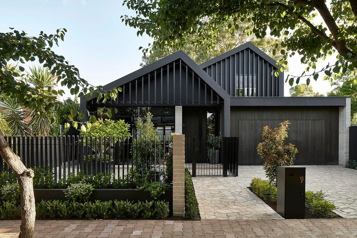 Twin dark gables face the garden and street.