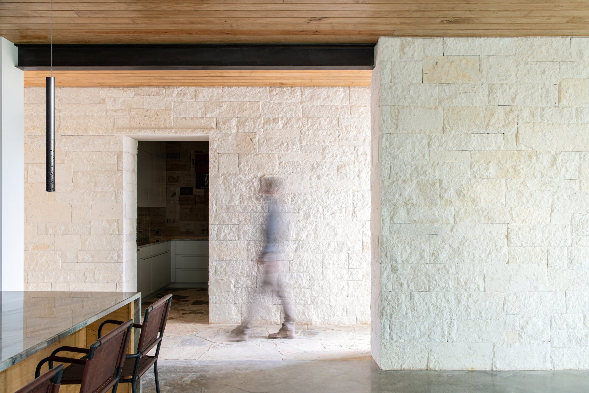 Native limestone walls framing a covered entrance