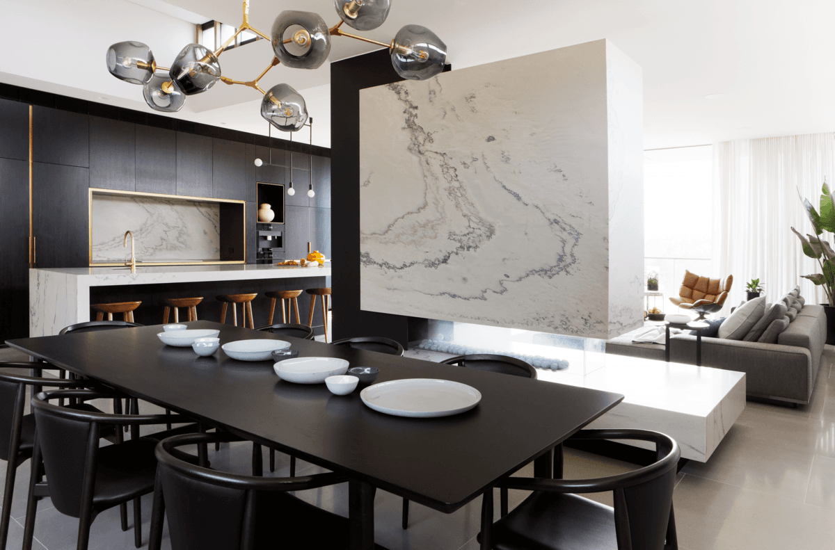 The stone kitchen and dining area connect with the living space beyond.