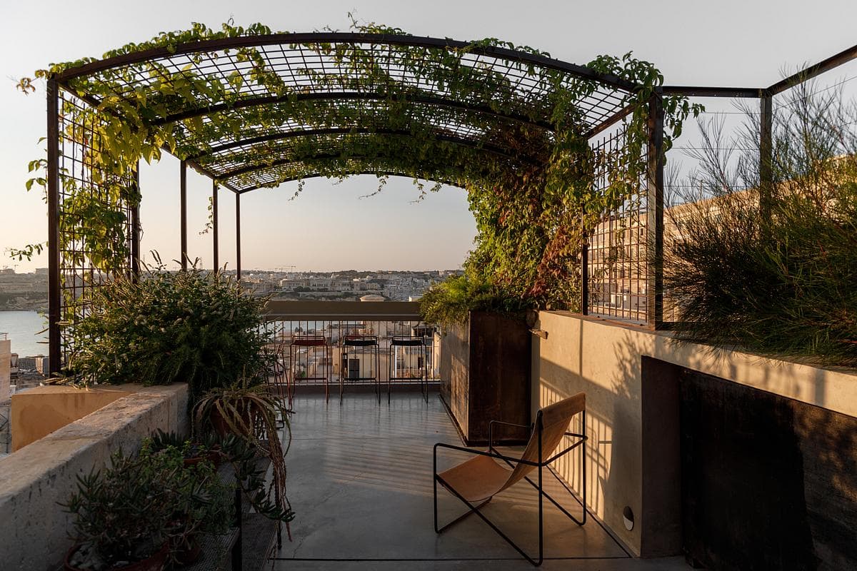 A planted pergola shelters a terrace looking towards Valletta’s harbour.