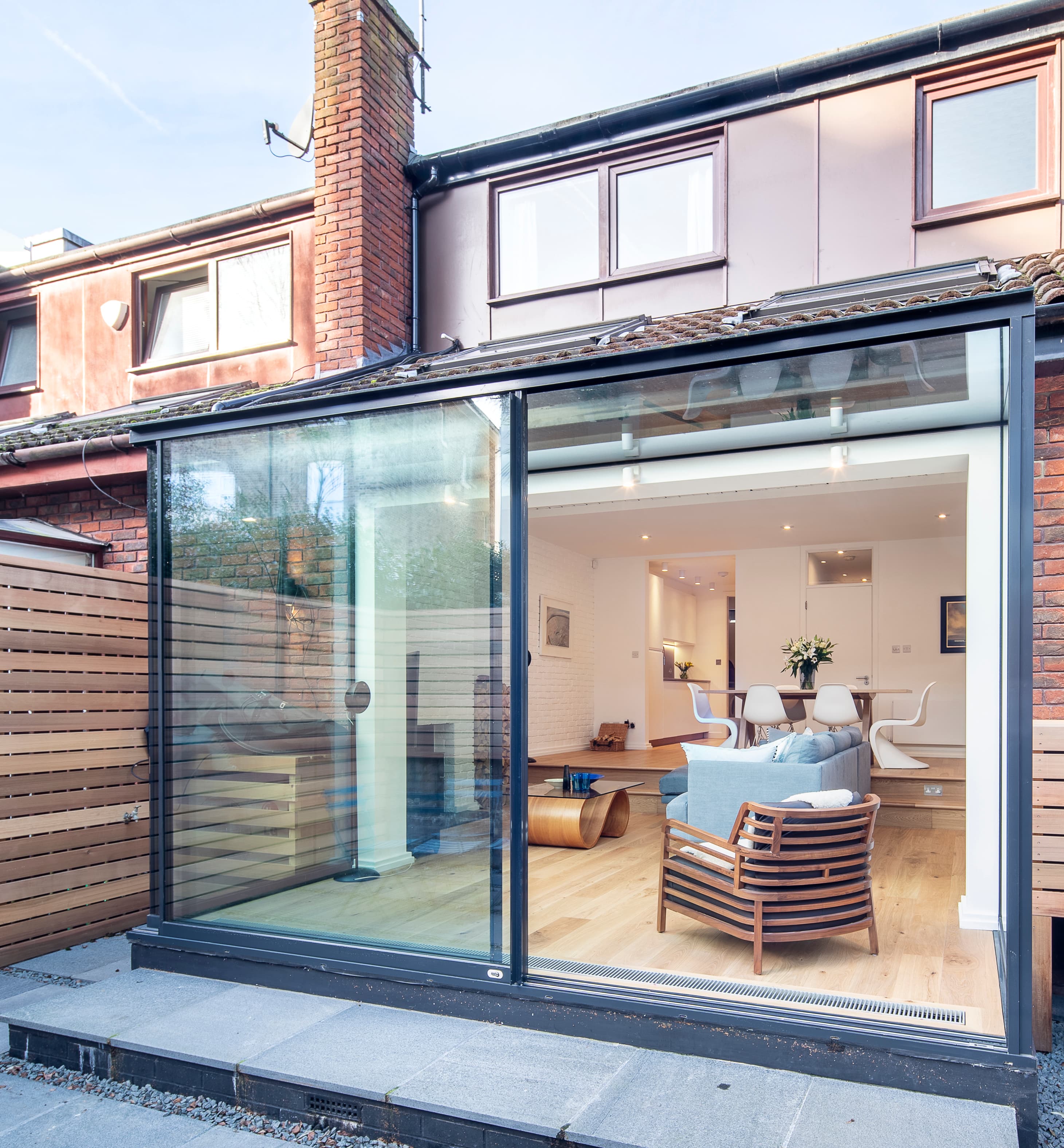 The glazed extension meets the existing rear elevation