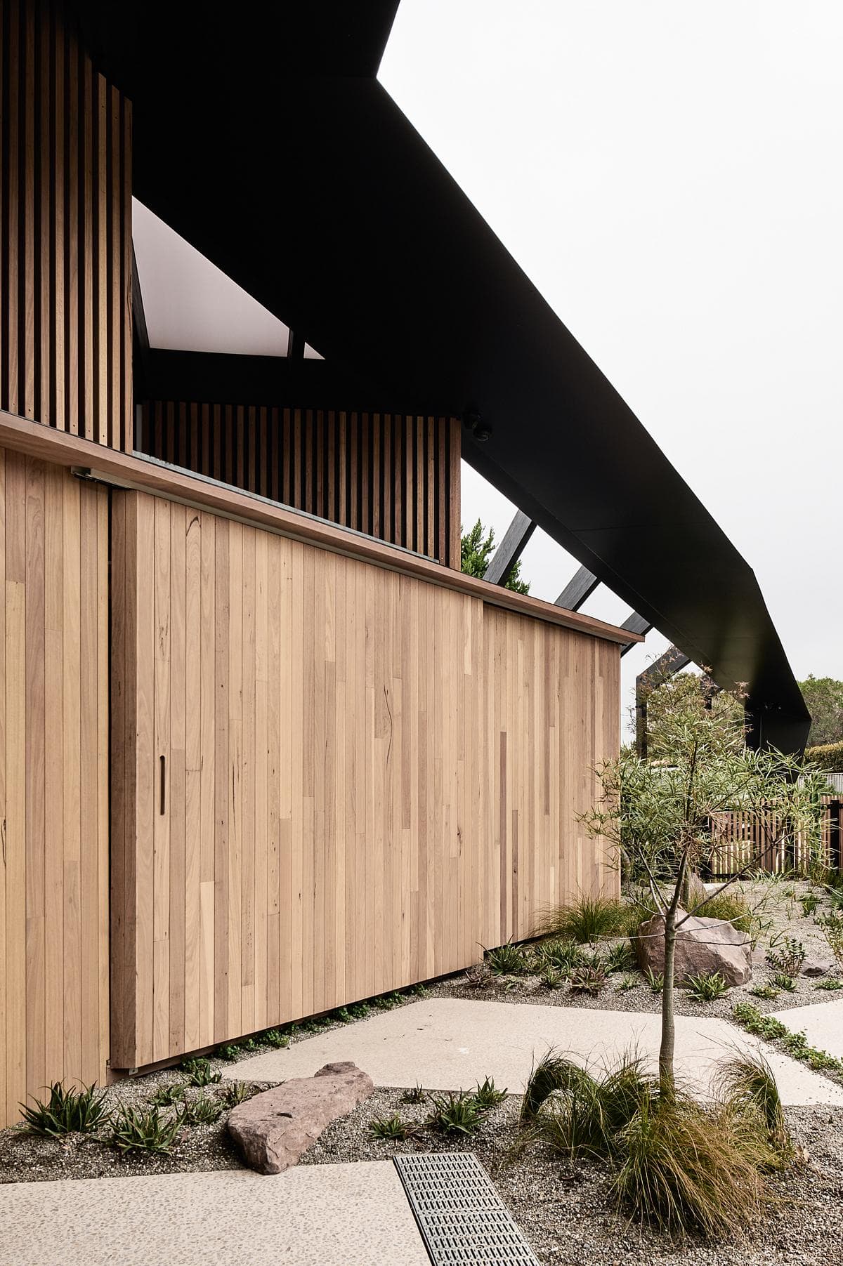 Timber cladding and eaves beside the native planting