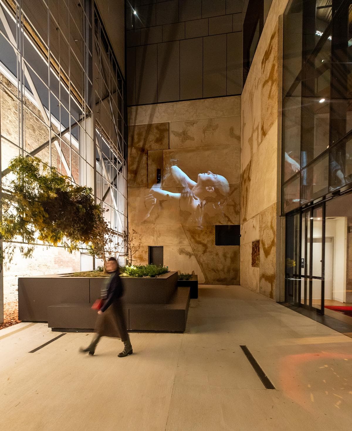 A tall glazed foyer connects circulation spaces with the building’s retained historic fabric.