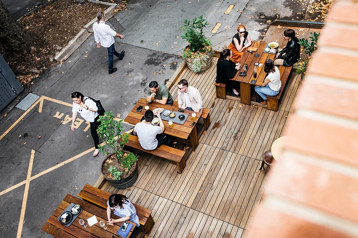 Outdoor dining deck within the laneway