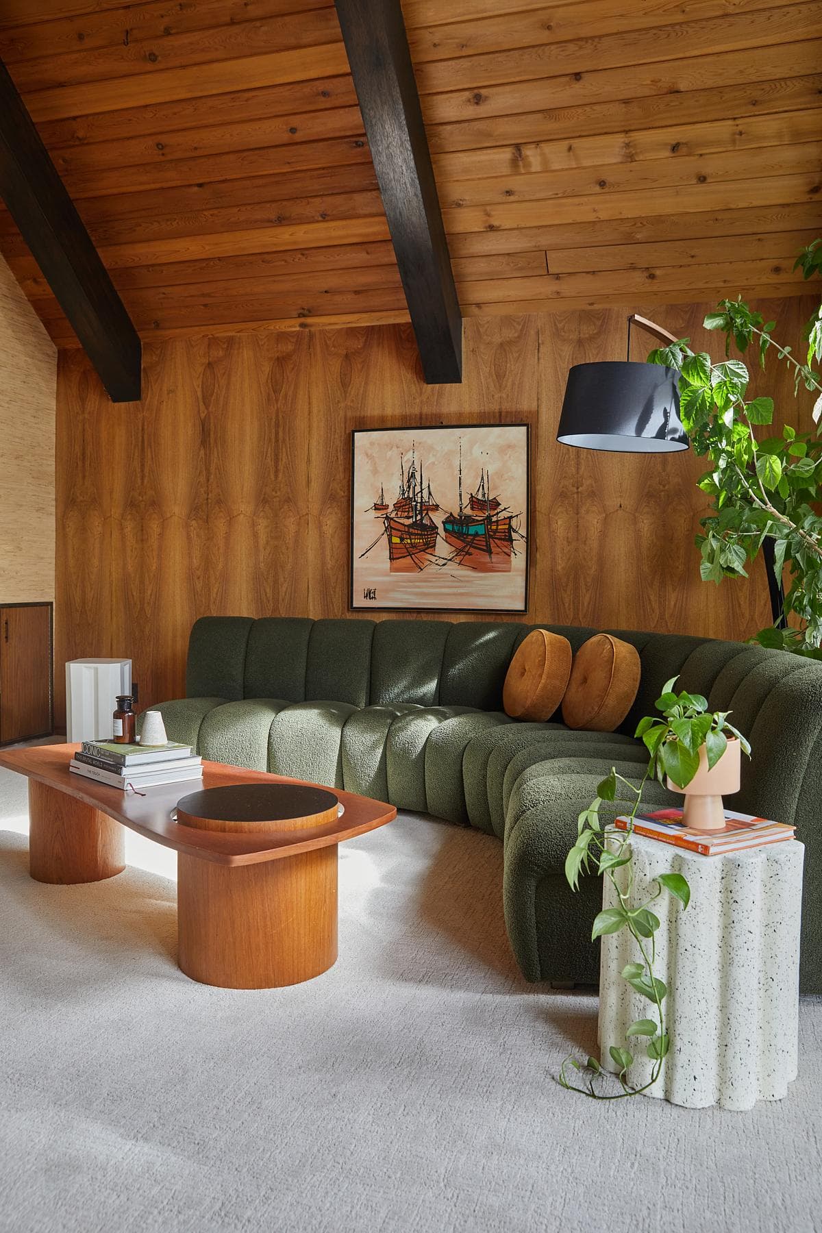 Timber walls and a high ceiling define the living room.