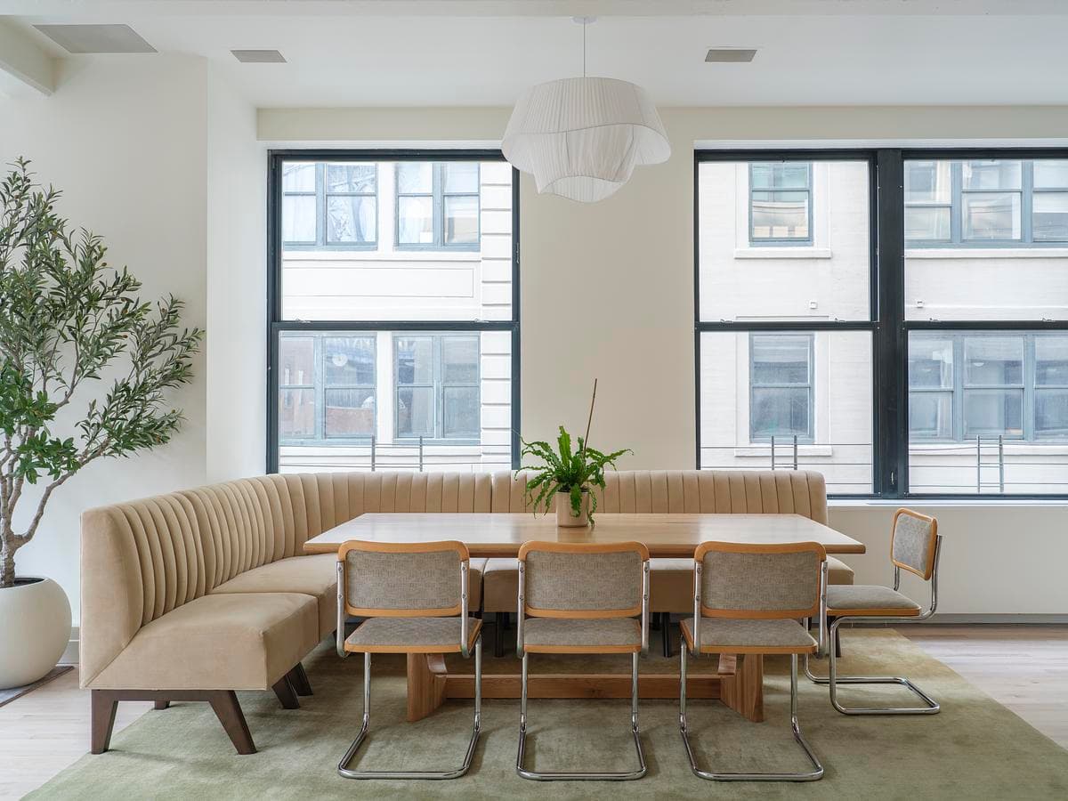 Built-in dining banquette and table beside the windows