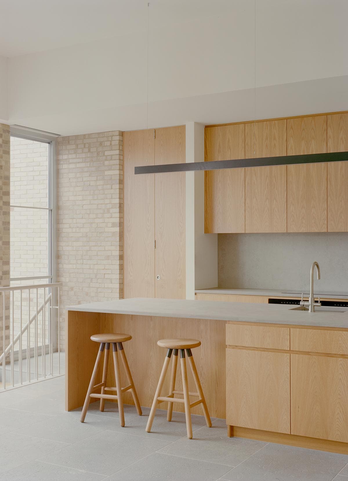 Timber joinery and a pale island define the upstairs kitchen.