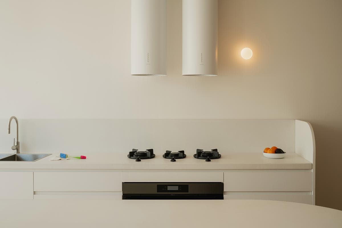 City Cottage: kitchen island, curved forms and pendant lighting