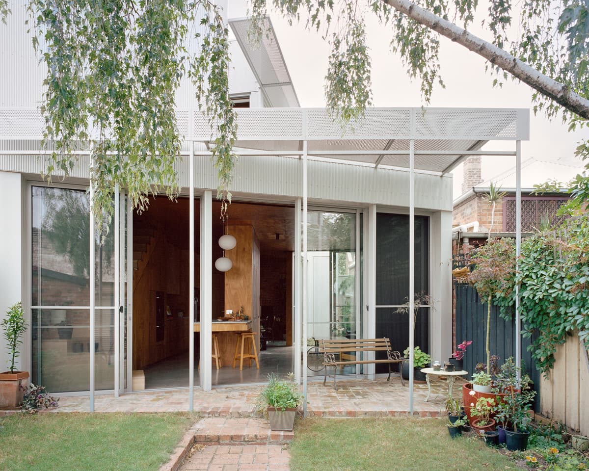 The ground-floor living space opens onto a sheltered garden terrace.