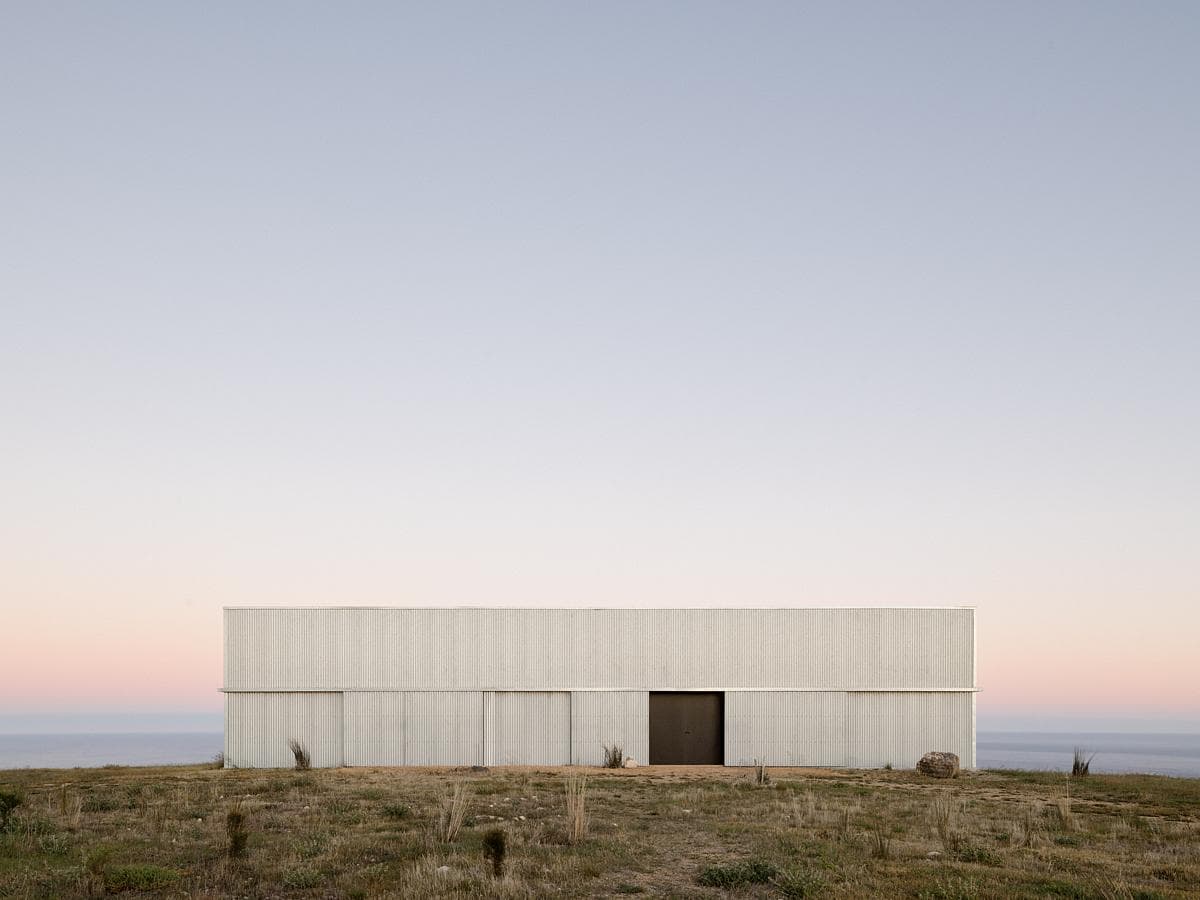 The corrugated-metal elevation facing the coastal landscape