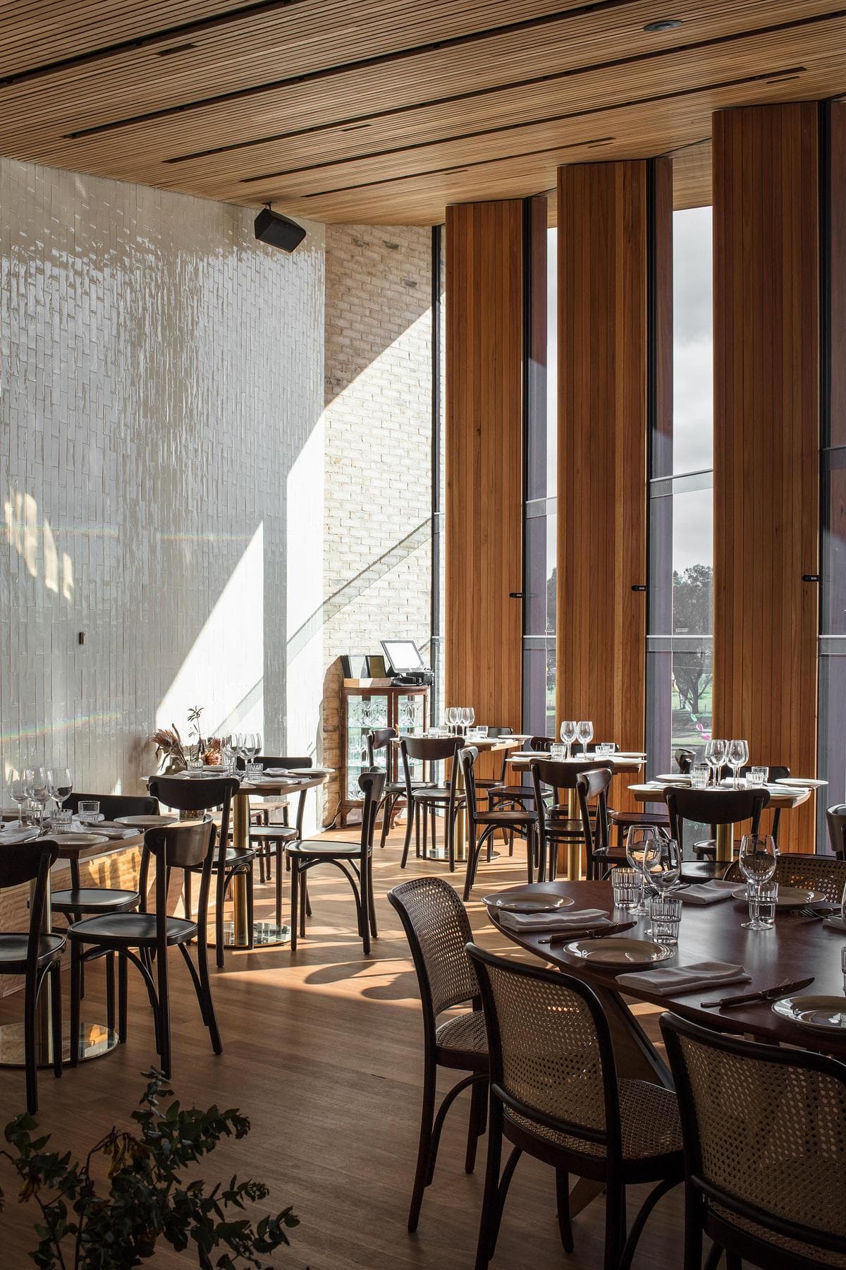 Restaurant seating beside the tall glazed river frontage
