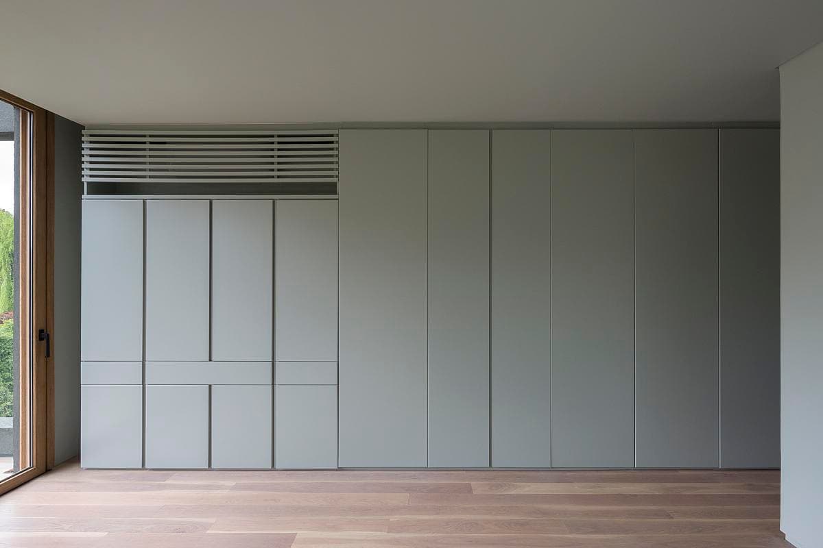 Full-height storage wall with integrated ventilation grilles