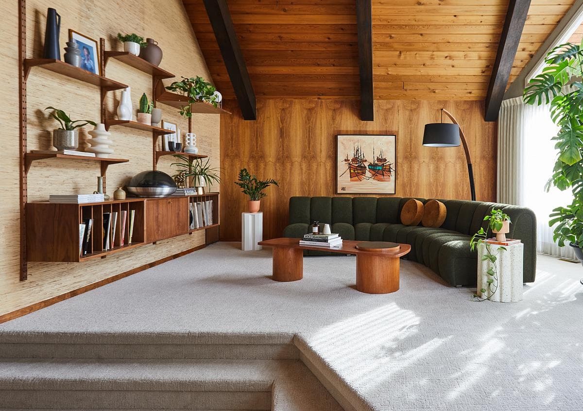 Living room with built-in shelving beneath the timber ceiling.