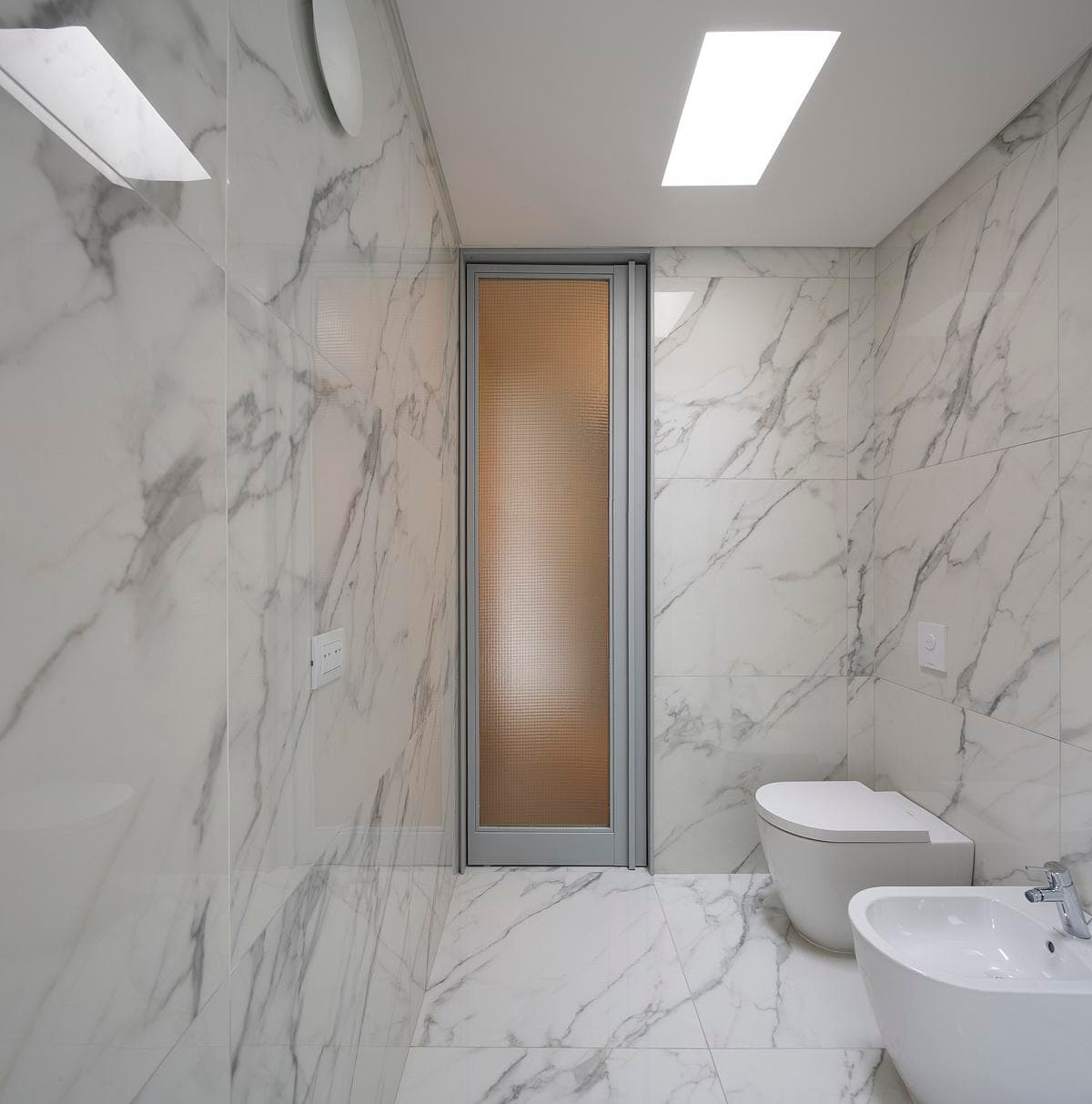 Marble-lined bathroom with a rooflight