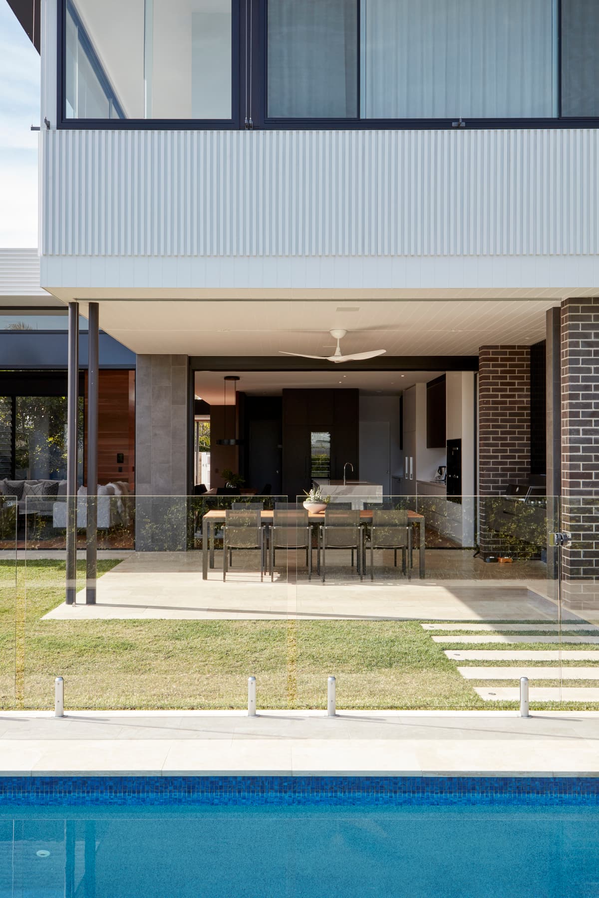 The garden elevation faces a lawn and pool.