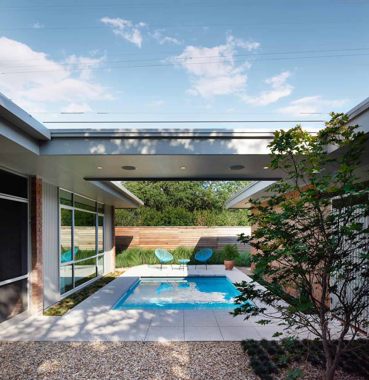 A planted courtyard and pool connect the house with its outdoor spaces.