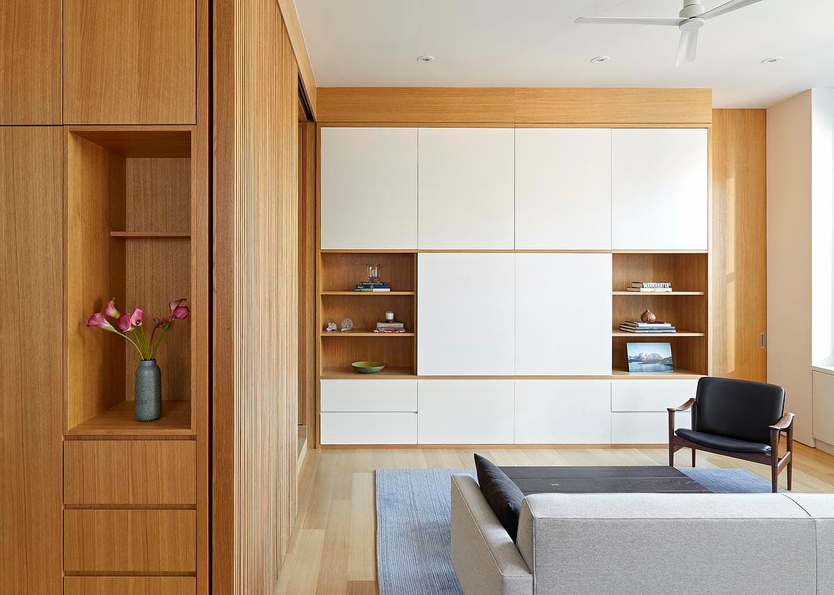 Full-height joinery frames the living area.
