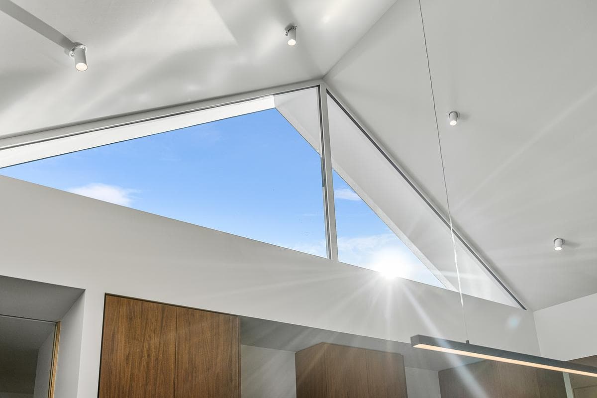High glazing lights the interior beneath the pitched roof.