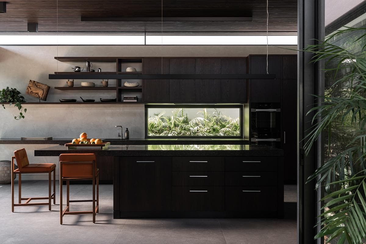 Kitchen and dining space framed by timber battens