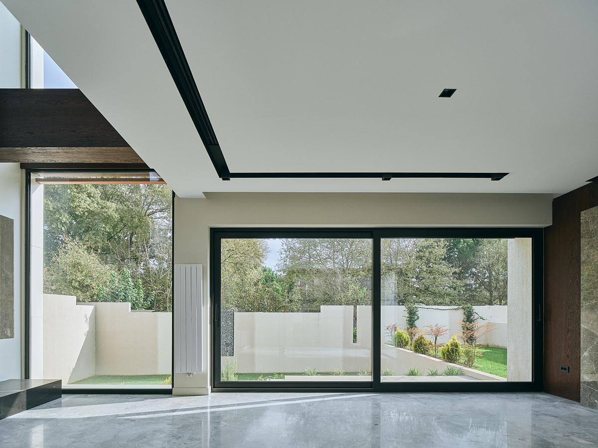 Broad glazing frames the garden from the living space.