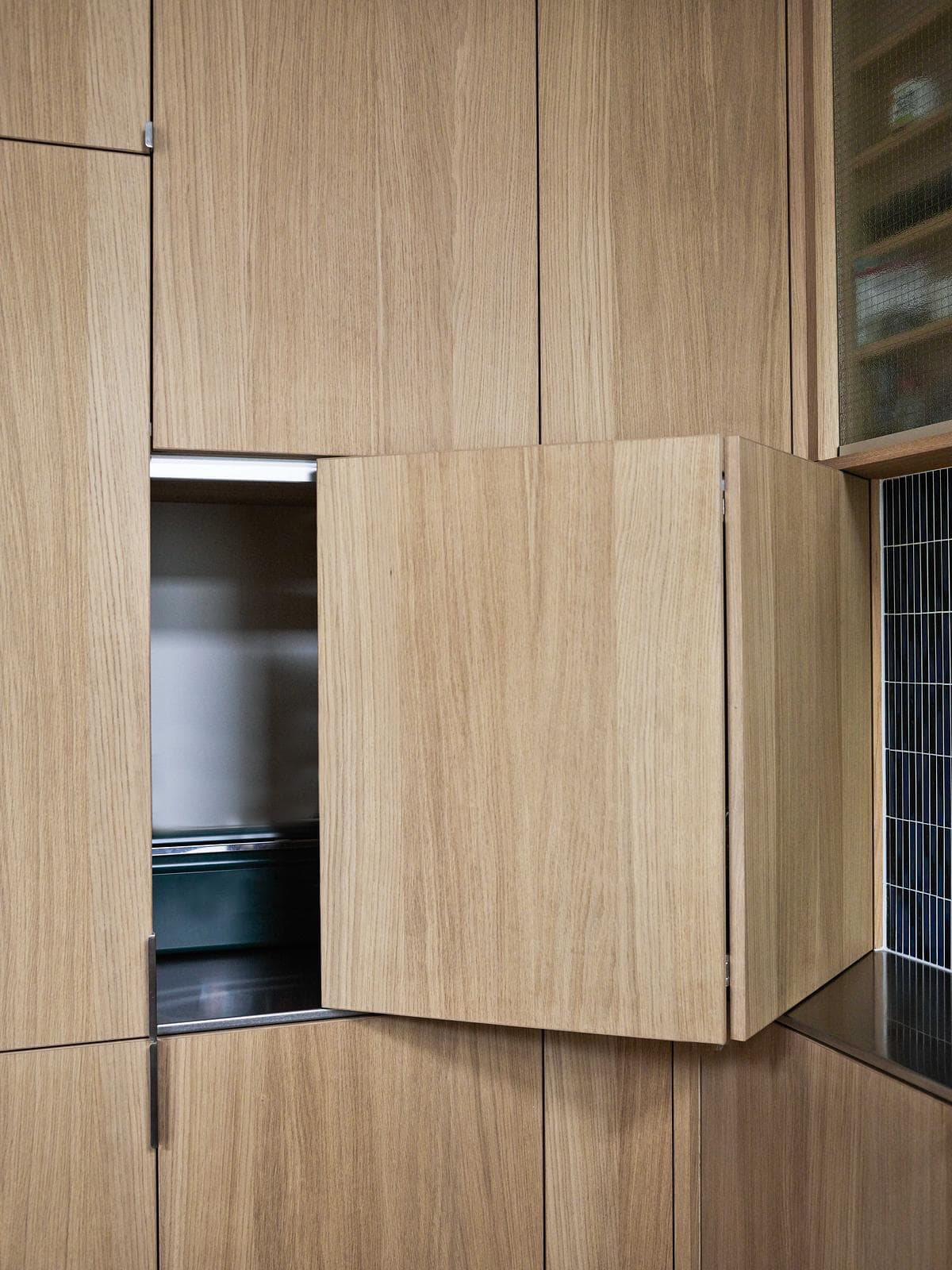 Concealed kitchen storage within the oak cabinetry