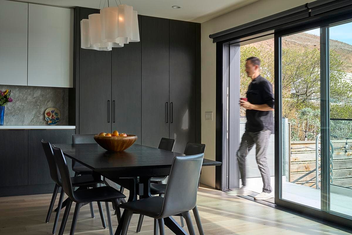 The dining space opens onto the planted terrace.