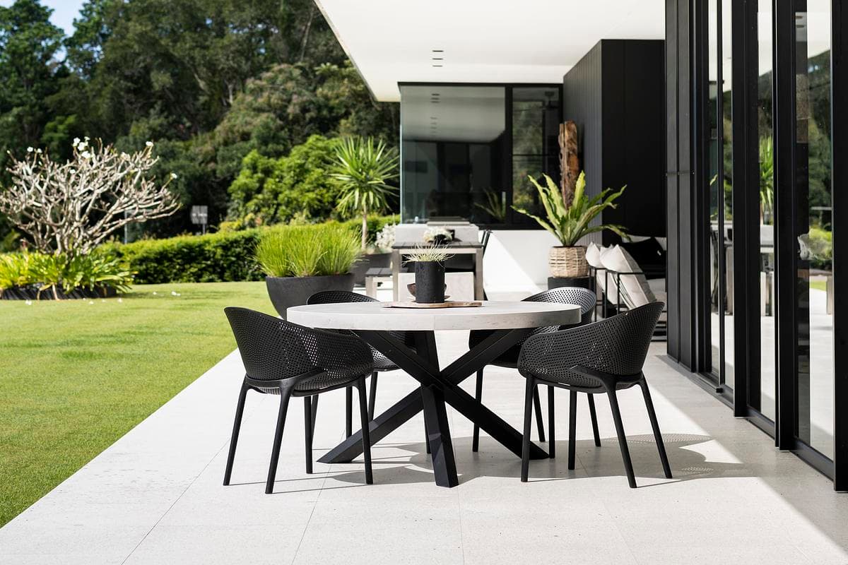 Outdoor dining on the terrace beside the glazed living pavilion.