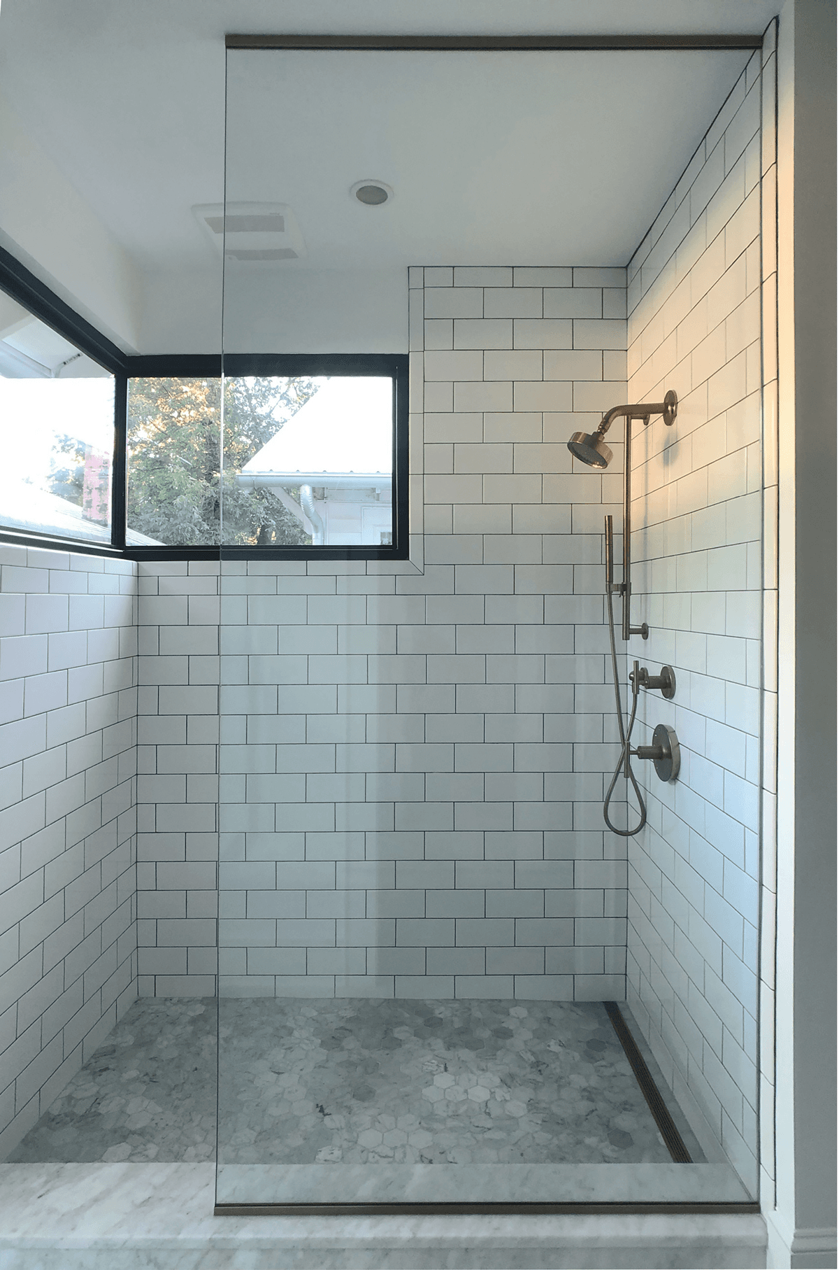 Ormewood Park Residence: tiled shower with a high window