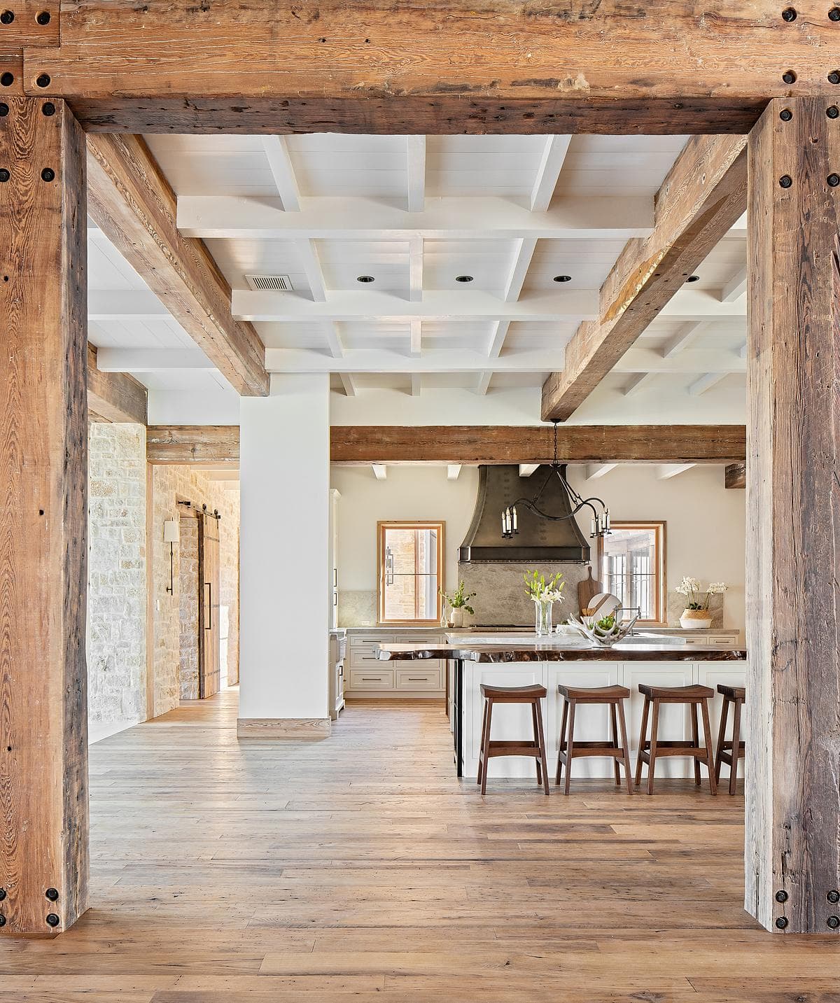 Timber beams frame the view into the kitchen.