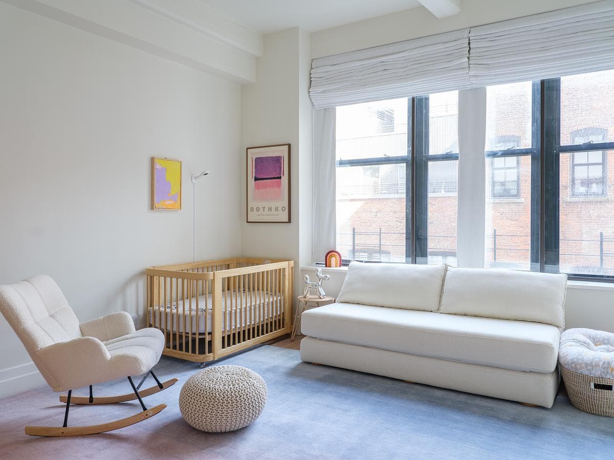 Living room seating and cot beside the loft windows