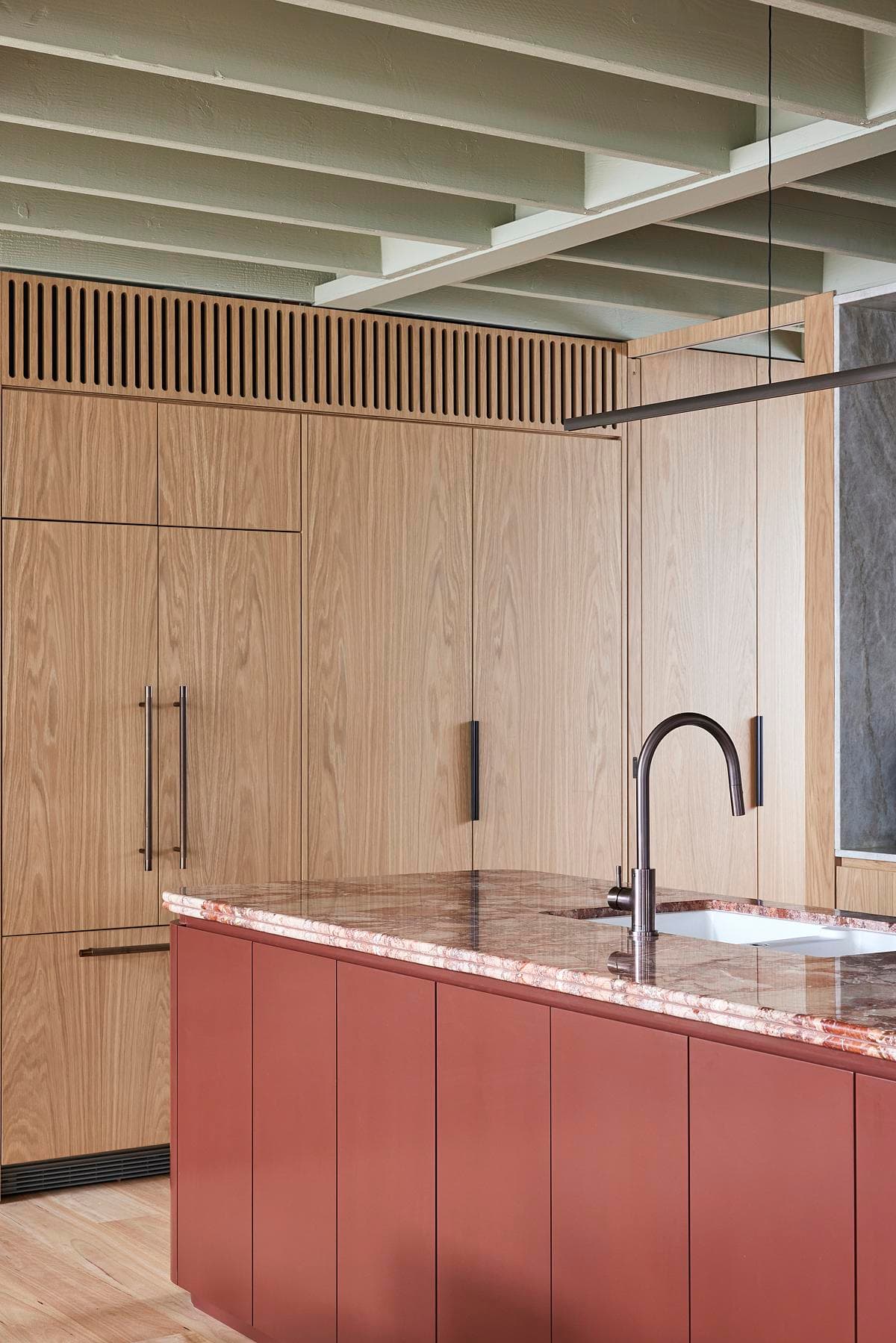 Kitchen cabinetry beneath the green ceiling