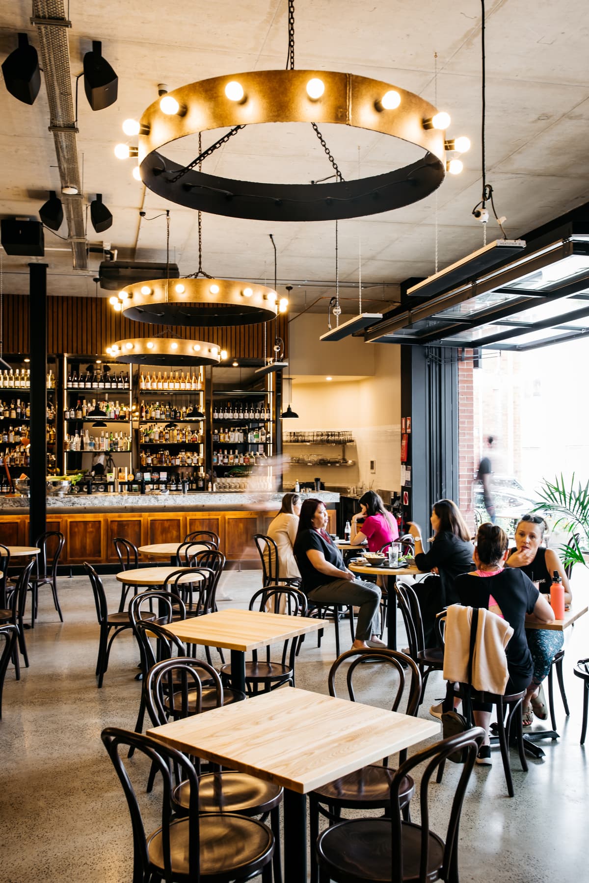 Bar seating beside large openings to Verity Lane