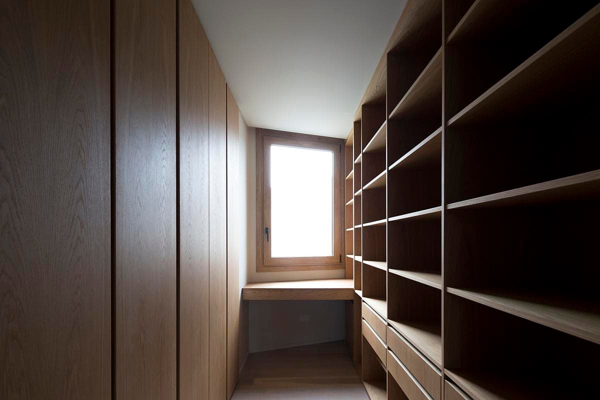 Timber-lined dressing space and shelves beside a window