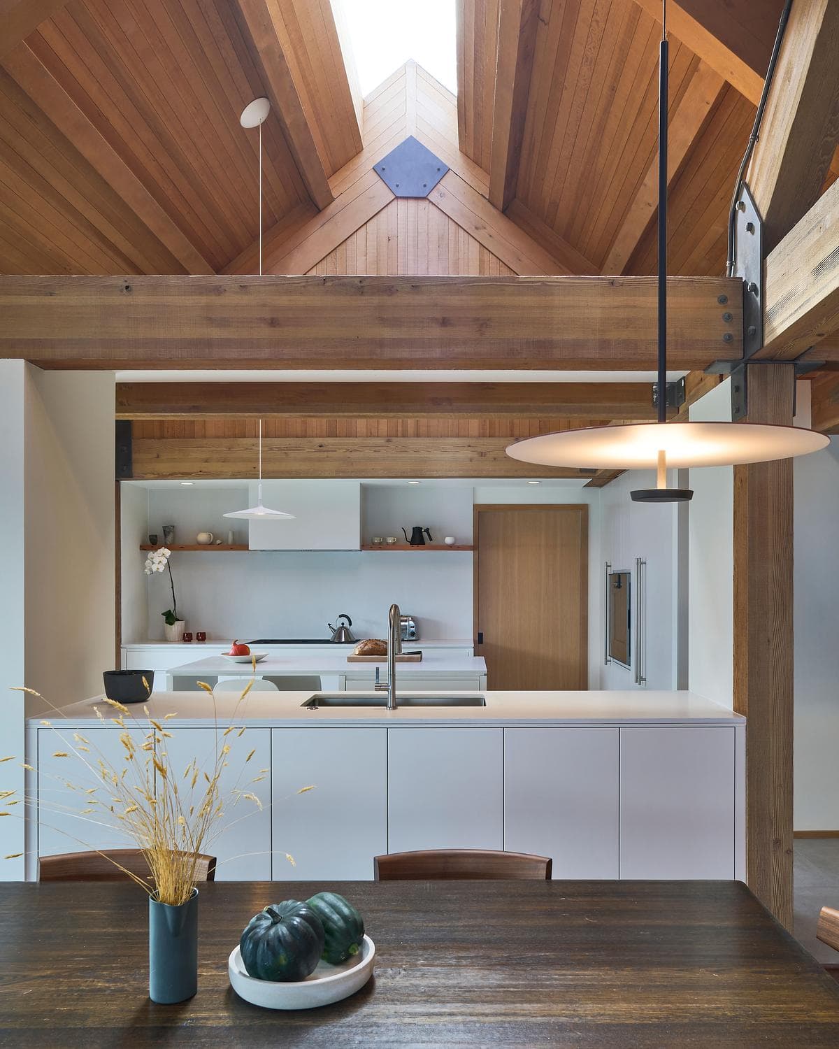Kitchen and dining area lit by a rooflight