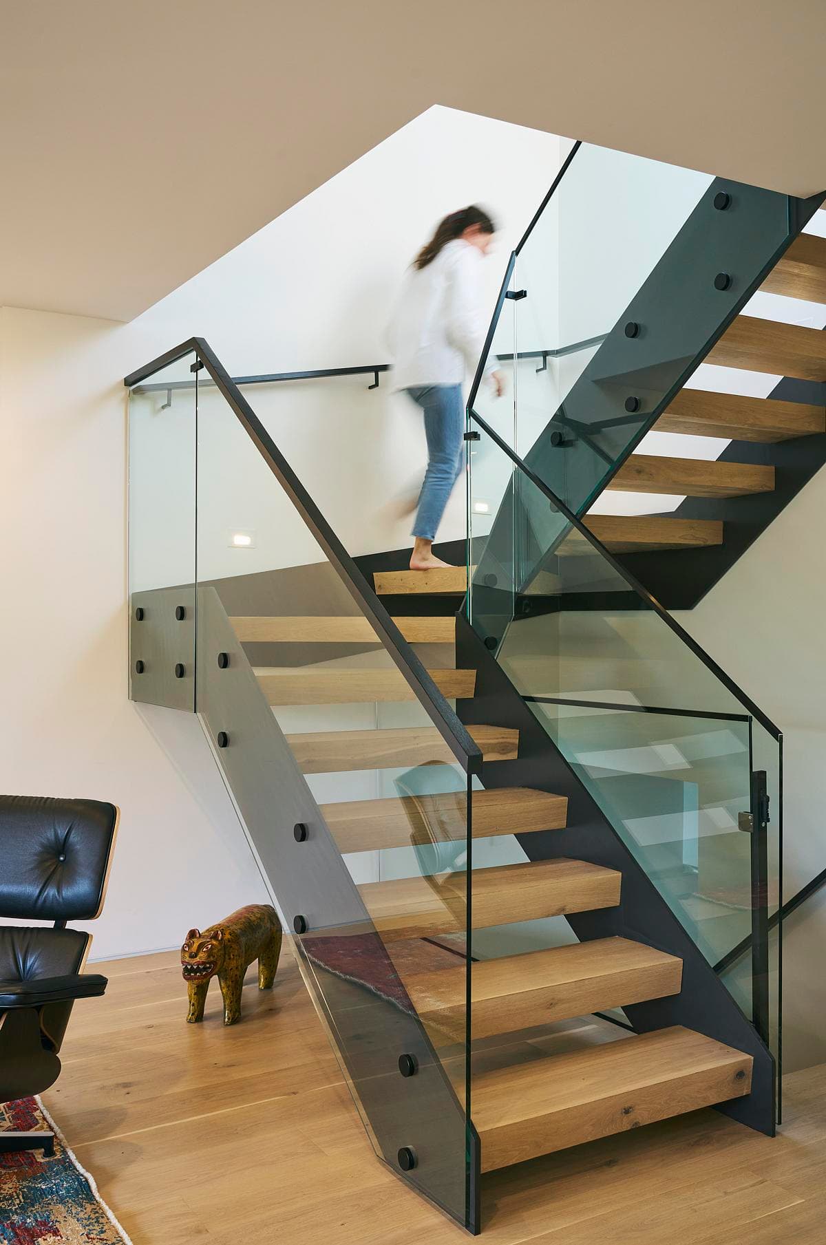The central stair rises towards daylight from the roof.