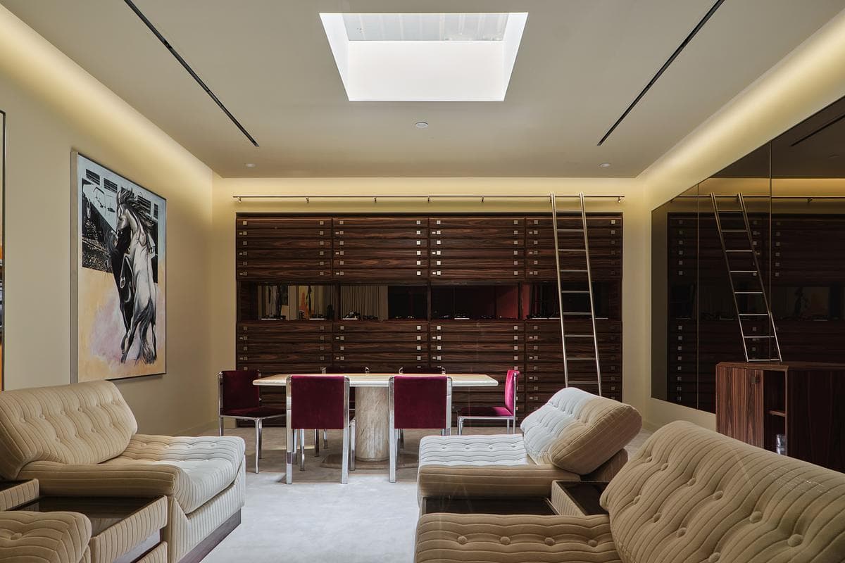 Cream seating, dark joinery and a skylight shape the private VIP room.