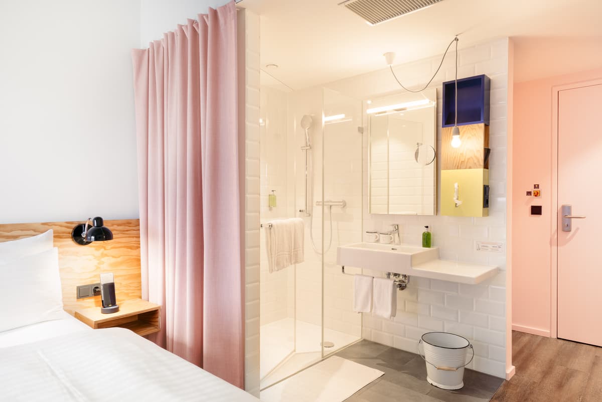 Curtains divide the sleeping and washbasin areas.