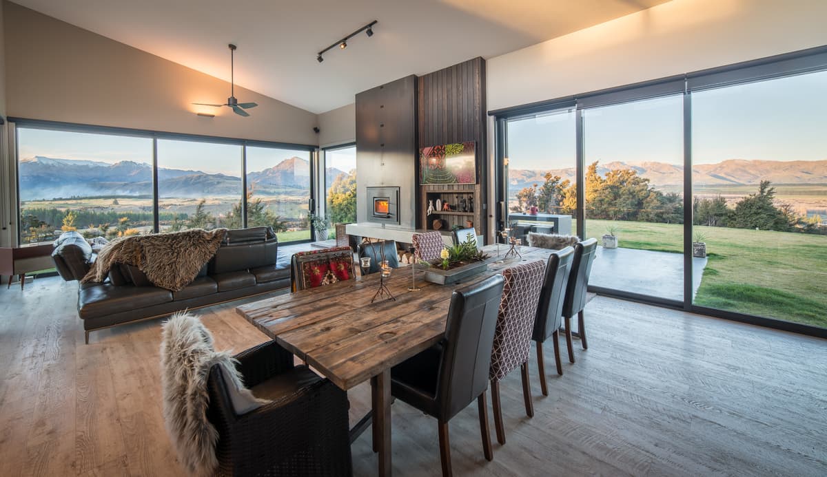 The dining area looks towards the garden and mountains