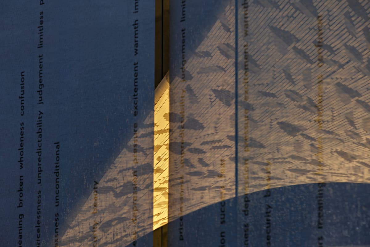 Words on the enclosure overlap with shadows from the woven fabric.