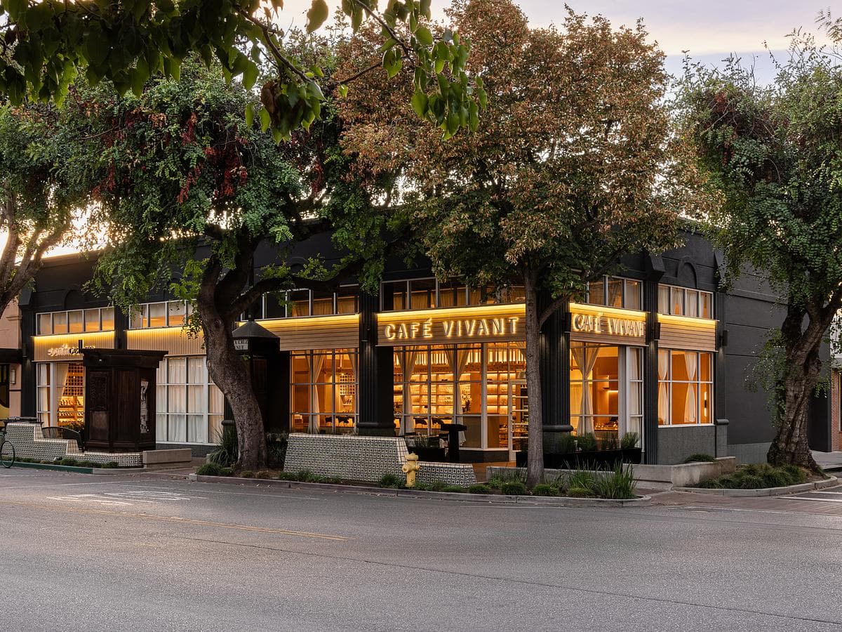 Cafe Vivant’s illuminated corner frontage and street trees