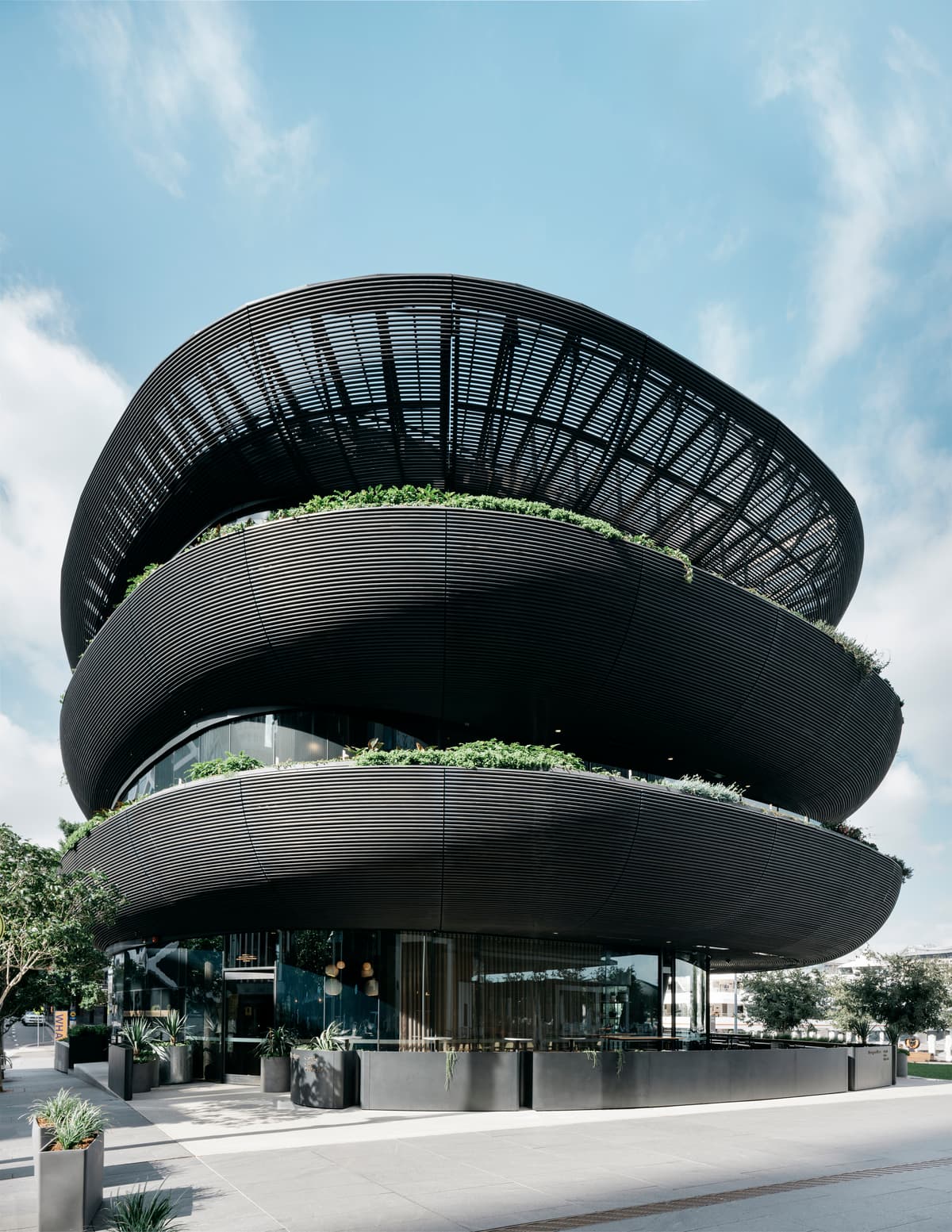 The building’s stacked balconies frame the hospitality spaces.