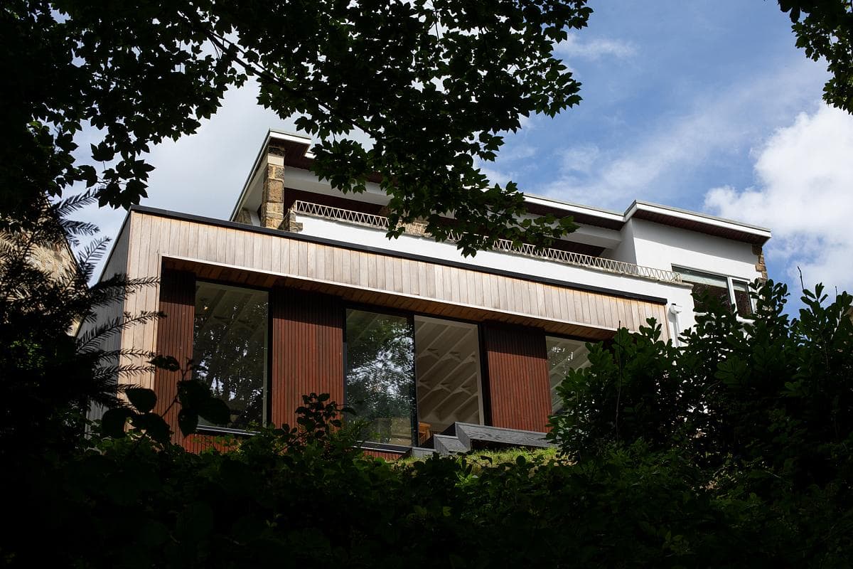 The rear extension meets the steeply planted garden.