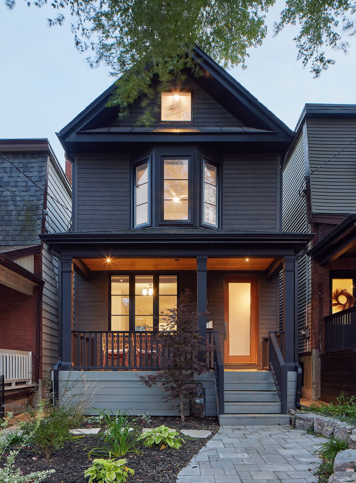 The renewed street elevation retains the house’s pitched-roof profile.