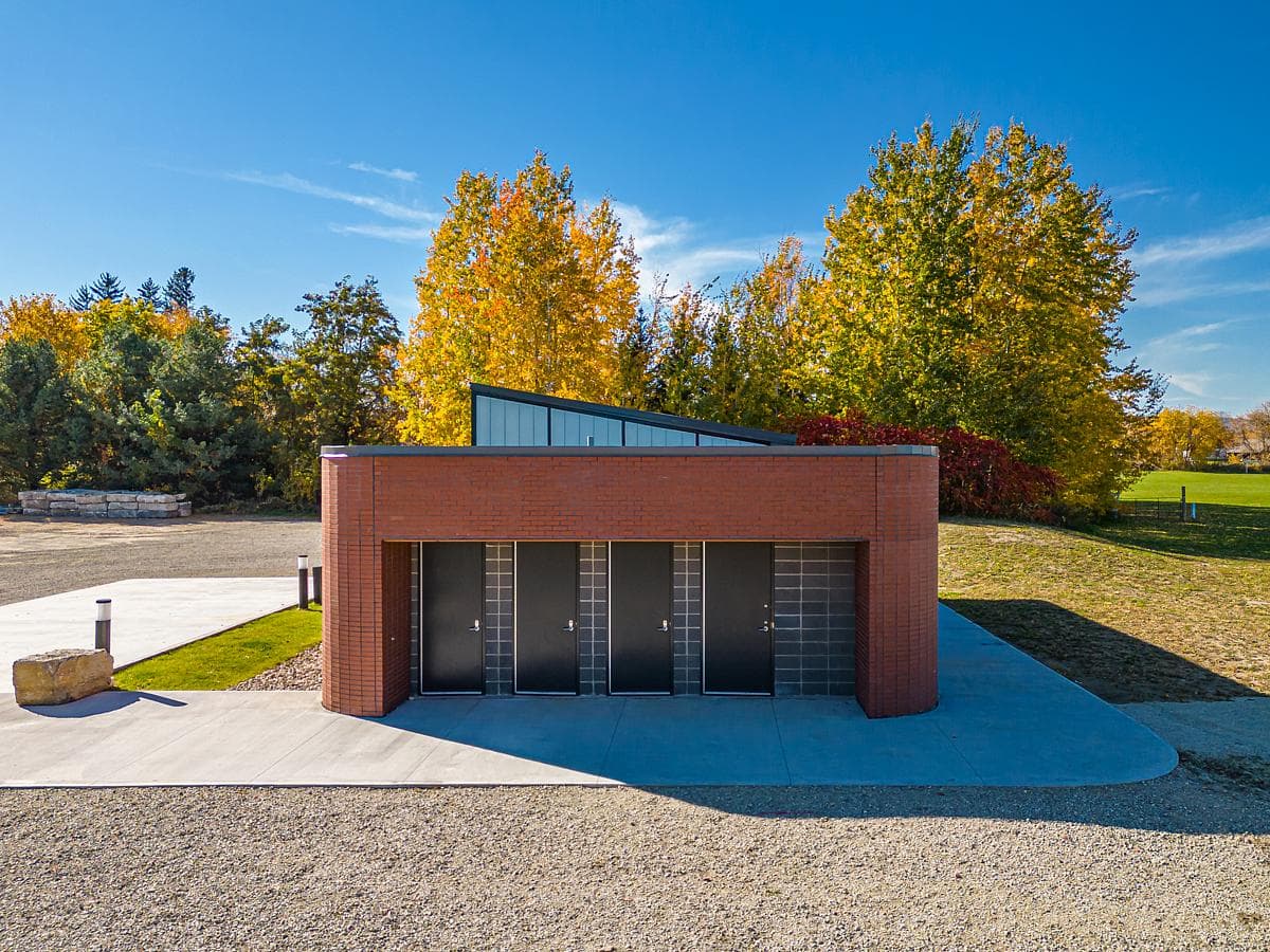 The washroom entrances face the approach through the park.