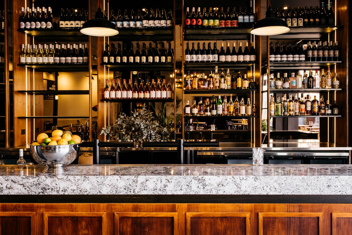 Back-bar shelving and stone-topped counter in the main bar.