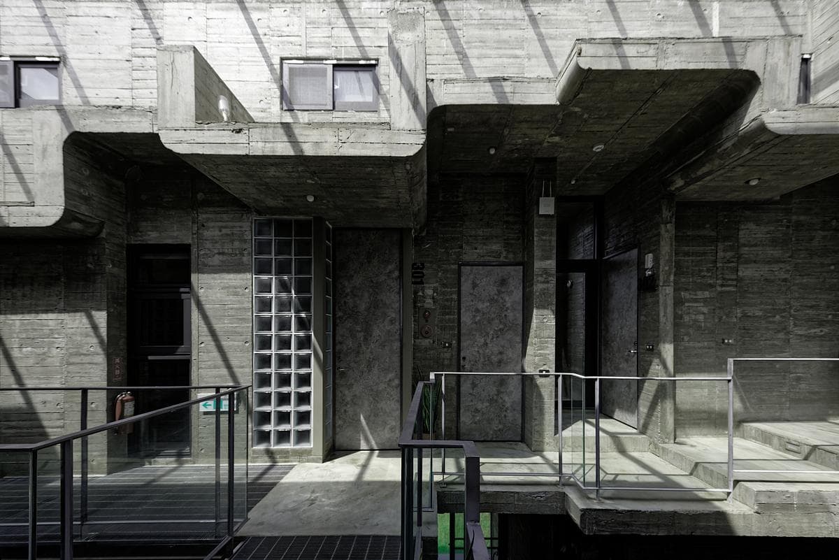 Undulating concrete floor plates and a glass-block entrance