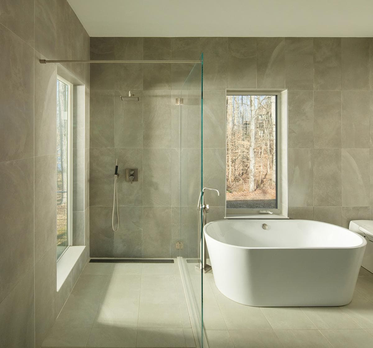 Bathroom with a freestanding bath and woodland view