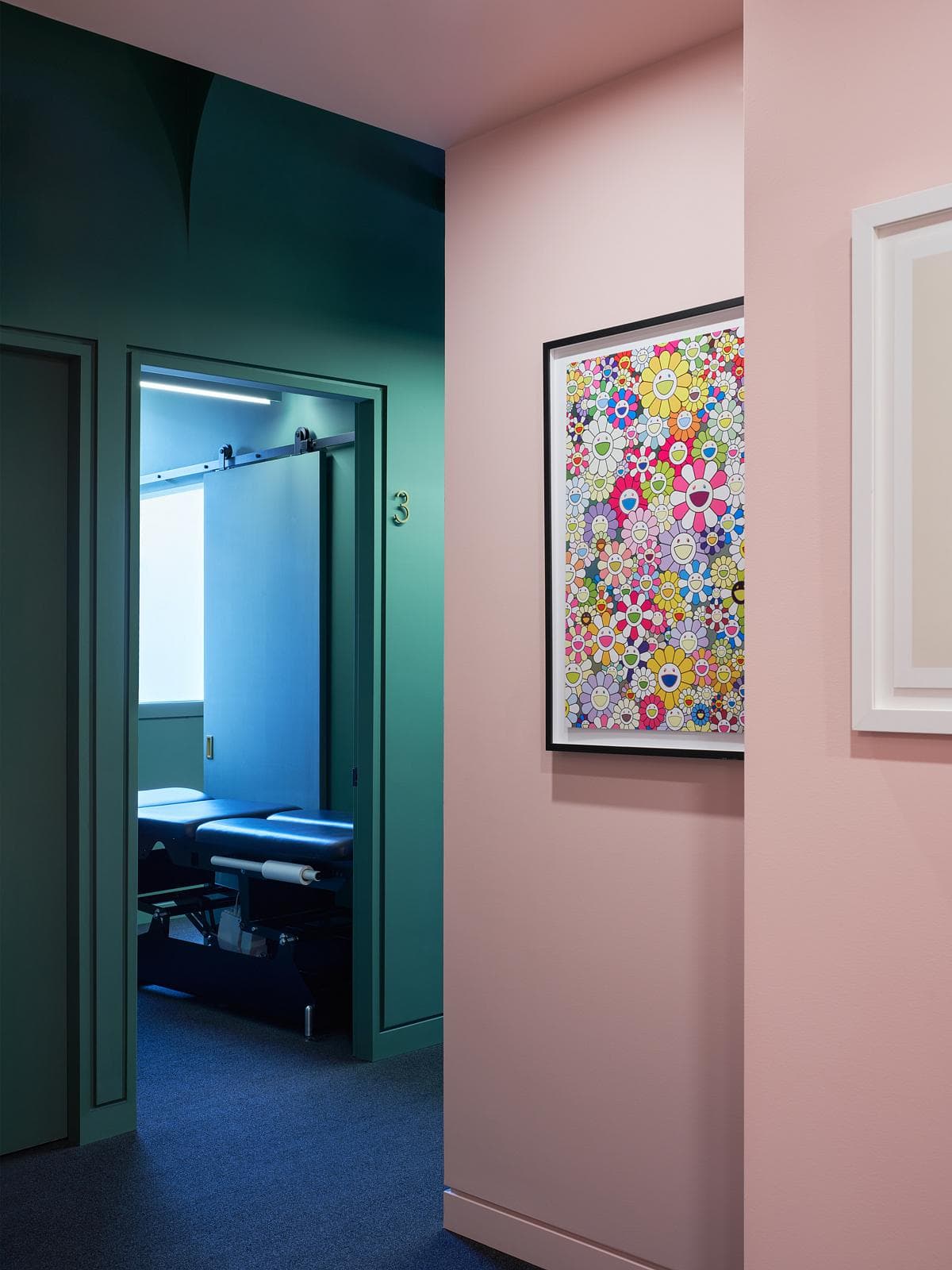 Pink service area beside a green-framed treatment room