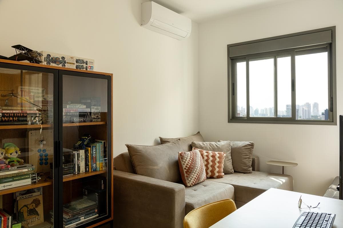 The living room combines existing furniture with new plywood joinery.