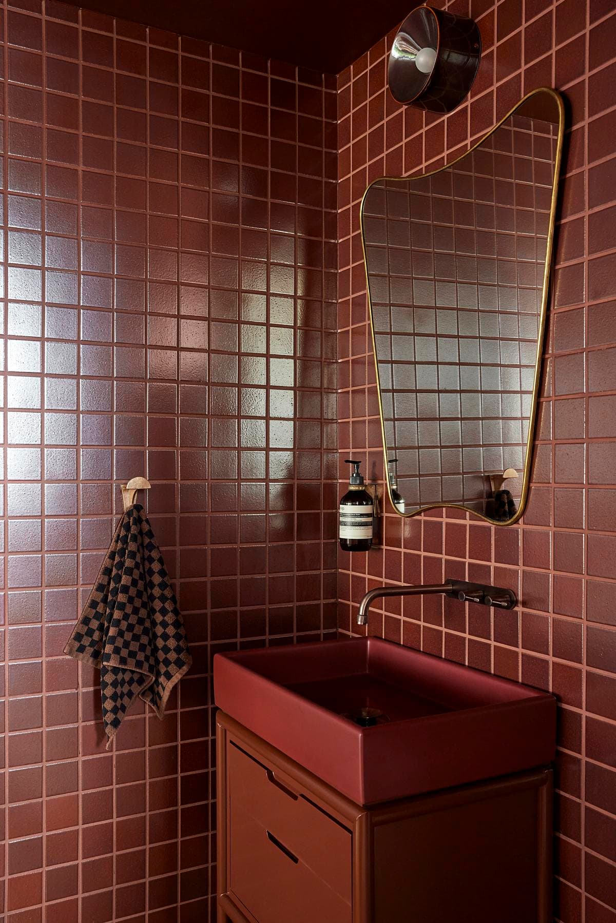 Red tiled bathroom with timber joinery
